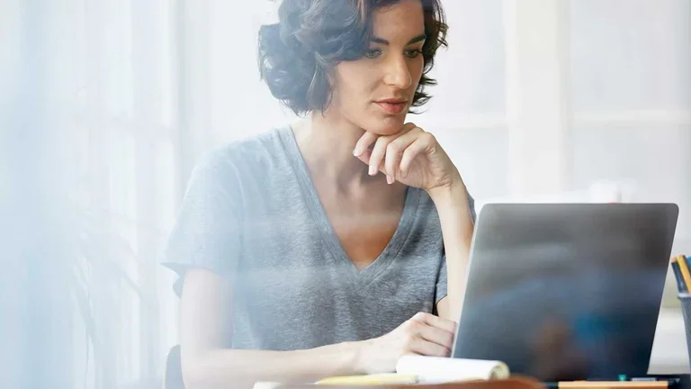 Frau sitzt vor dem Laptop
